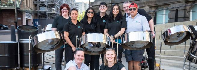 Musicians stood with steel pans. 