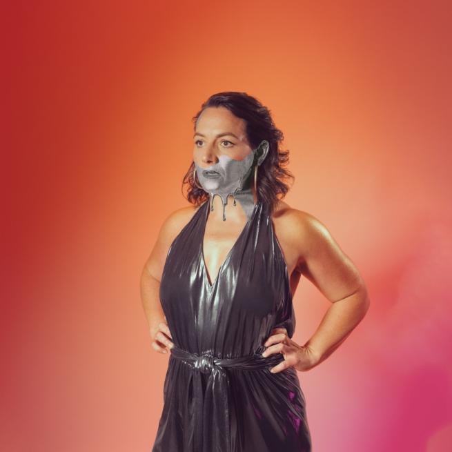 Jessica Forstekew in a metallic outfit with metallic painting dripping from her face.