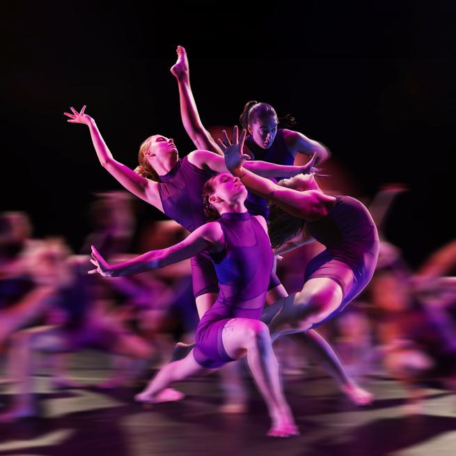 Group of dancers wearing purple costumes