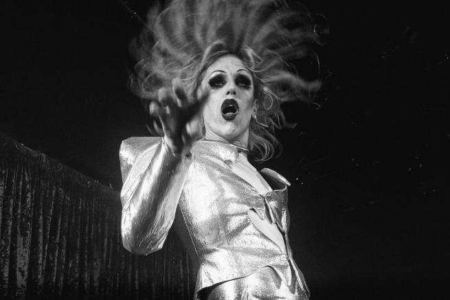 A black and white photo of a fabulous drag queen in performing