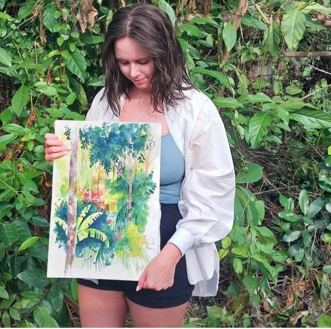 Amy holding one of her illustrations 