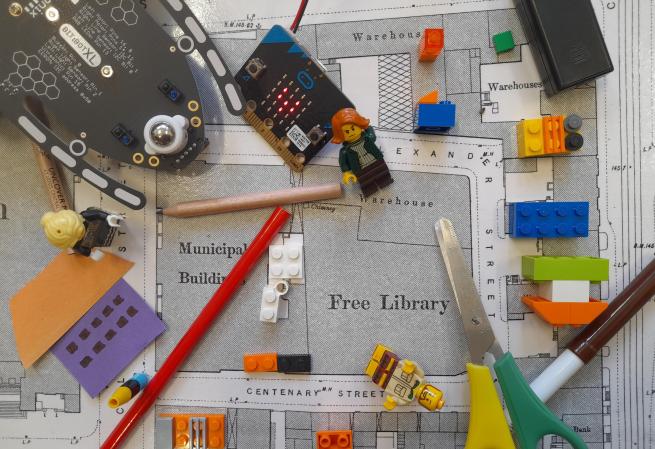 Lego, a Micro:Bit, Bit:Bot and stationery on a Victoria OS map of Leeds Central Library