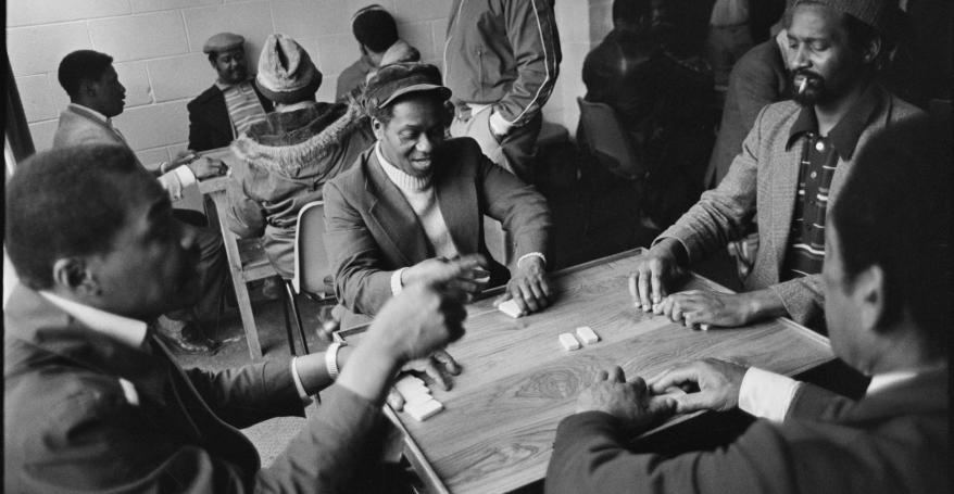 A group of men playing dominos at Leeds West Indian Centre, Laycock Place. Apr 1983. © Historic England Archive.
