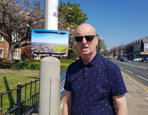 man standing next to a lamp post