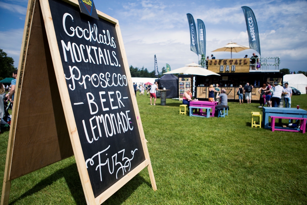 Chalkboard sign advertising a festival, featuring various beerand event details.