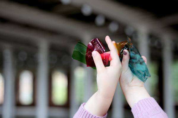 a child's hands holding something in the air