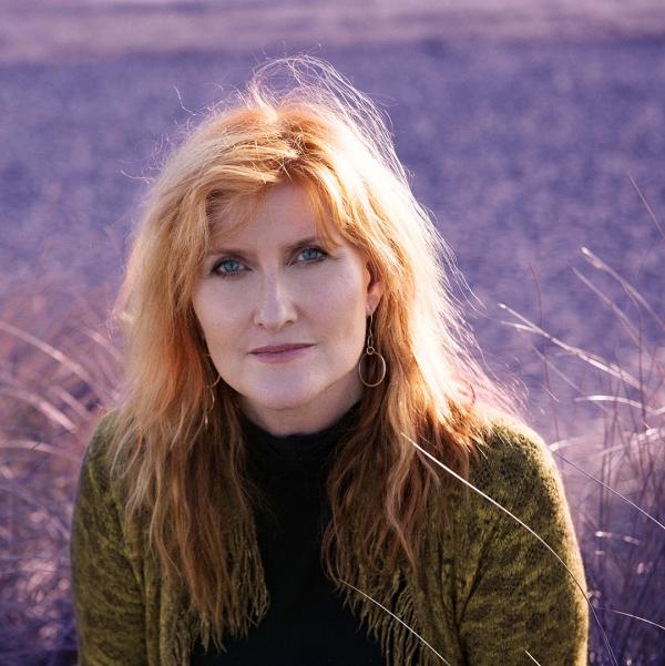 A headshot of Eddi Reader in front of a purple heather field