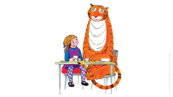 A tiger and a child sat at a table having tea.