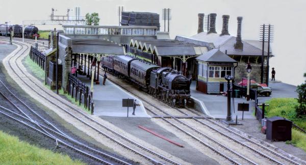 Steam train waiting at a station platform