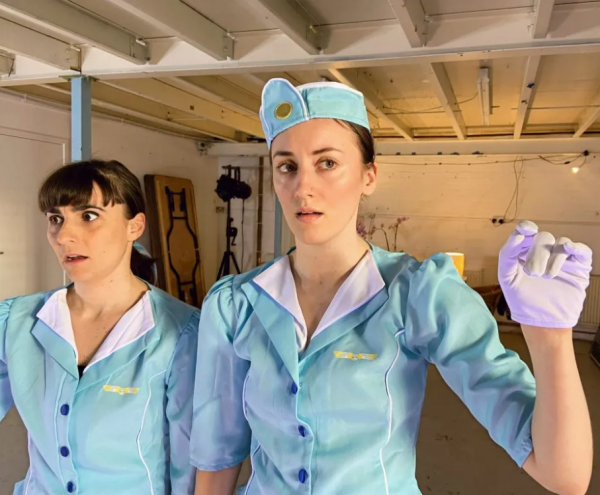 two women in light blue air hostess costumes
