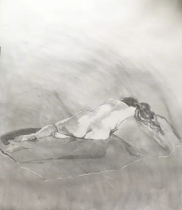 A pencil and charcoal drawing of the back view of a female life model in a reclining position
