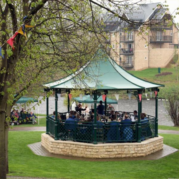 Musicians performing in a bandstand. 