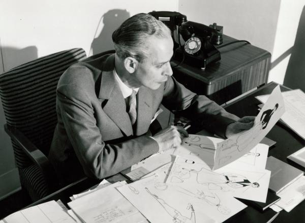 A black and white image of a man working at a desk