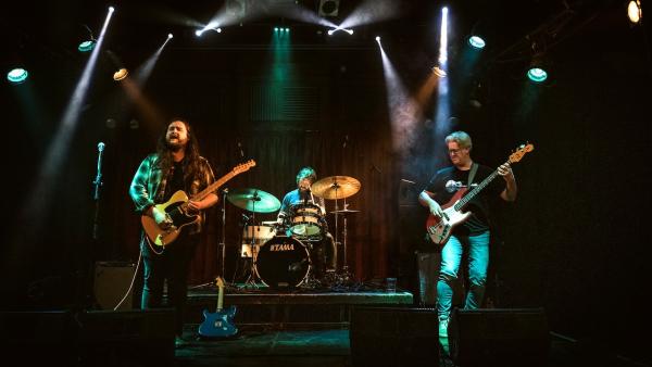 Alex Hamilton delivering a searing solo with concentrated support by his band.