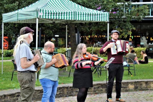 Musicians performing in a park.
