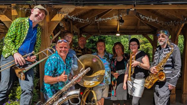 Homecoming Brass Band stood smiling. 