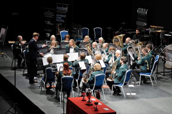 Musicians performing on a stage in a band.