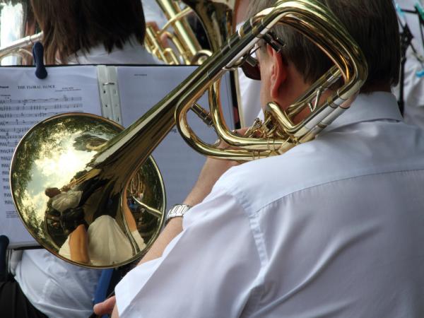 A musicians performing on a trombone.