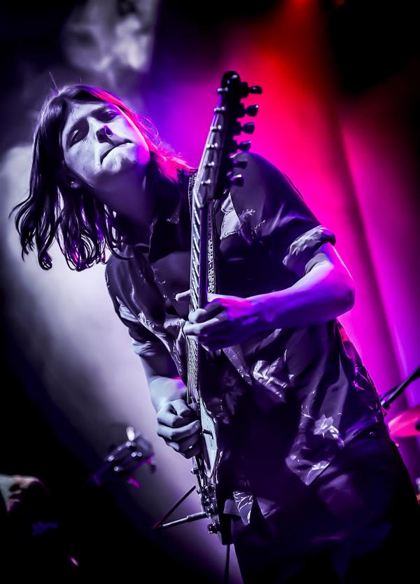 Image of Toby Lee delivering some searing blues solo on guitar with intense concentration.