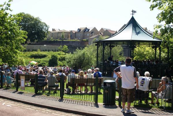People watching a band in the park. 