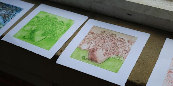 Images shows a selection of drypoint etchings drying on a window sill 