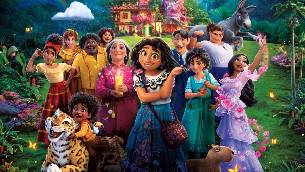 Animated picture of a large family of colourfully dressed people, stood in front of a colourful Columbian style house.
