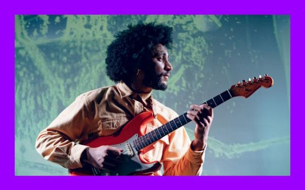 A man playing guitar.