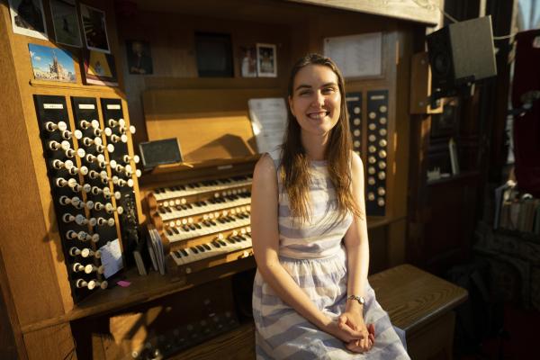 A musician sat on the organ bench.