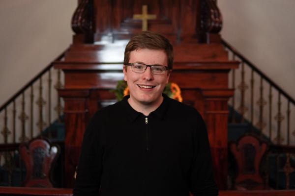A musician smiling at the camera.