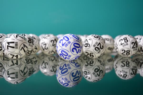 A picture of white bingo balls on a green background.