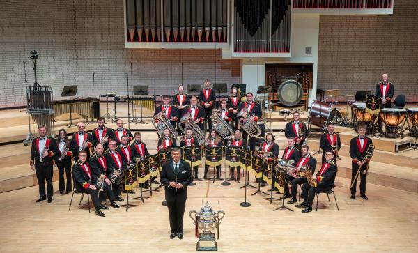 A brass band performing on stage.
