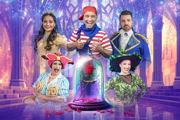 A red rose in a glass case sits surrounded by the pantomime cast.