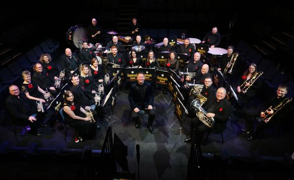 A brass band performing on a stage.