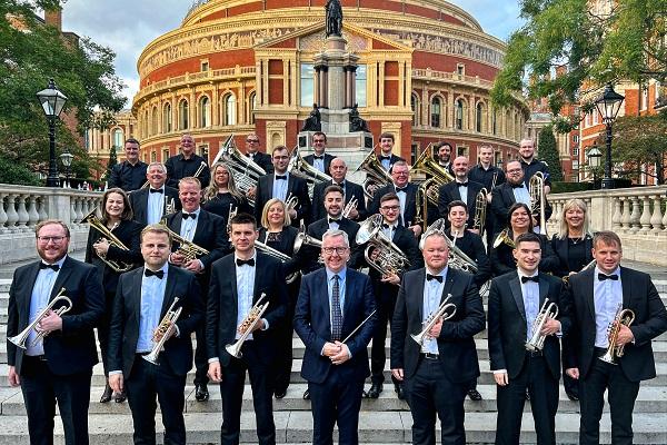 A brass band holding their instruments.