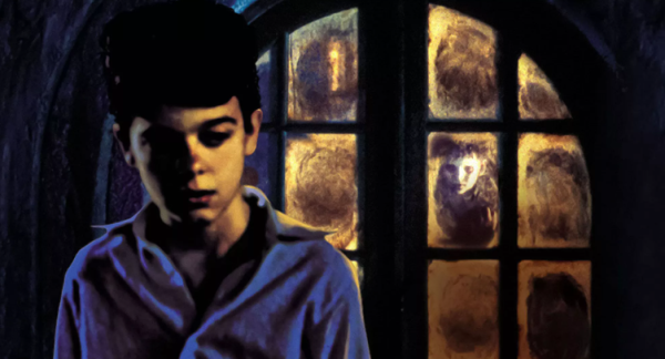 Boy in front of a window where there is a ghostly looking boy looking through it.