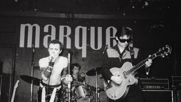 Rock band performing on stage.