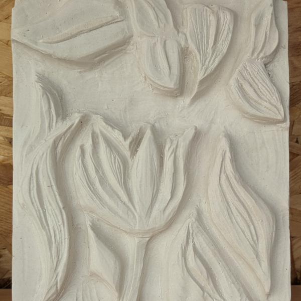 A plaster carving of flowers and leaves