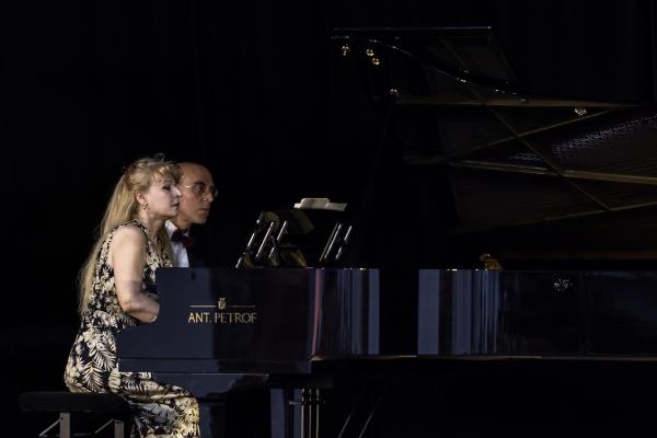 Duo Ardašev sat performing at a piano.