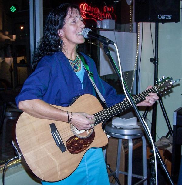 Picture of Paula Ryan playing guitar