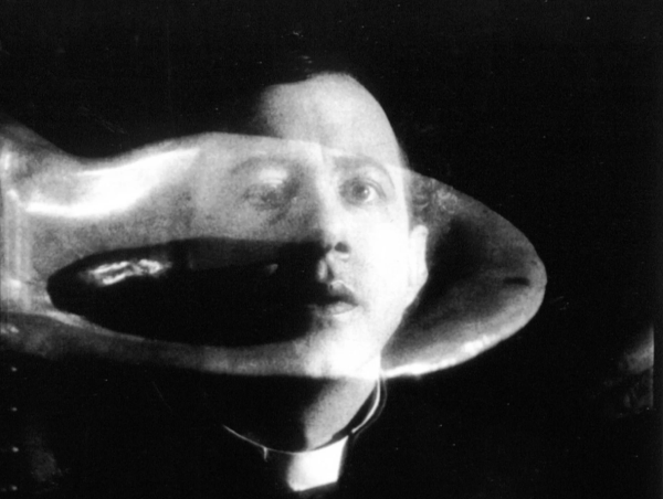 A man in a moan collar stare through a bubble-like shape