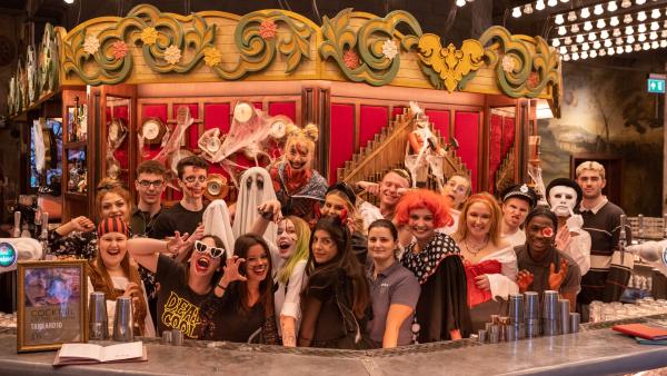 A group of people at Flight Club, dressed in Halloween outfits