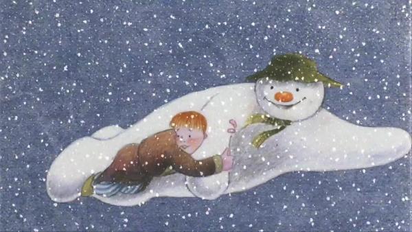 A snowman and a boy fly through a snowy sky in illustration style