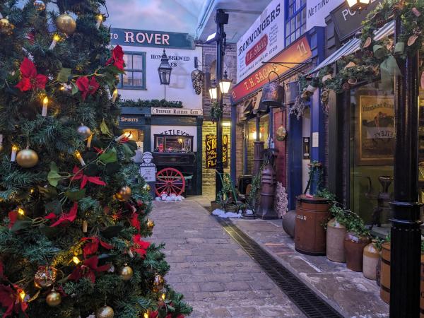 A picture of a Victorian street museum with a Christmas tree in the foreground