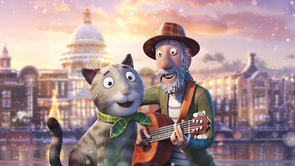 A picture of Tabby McTat and Fred holding a guitar and smiling