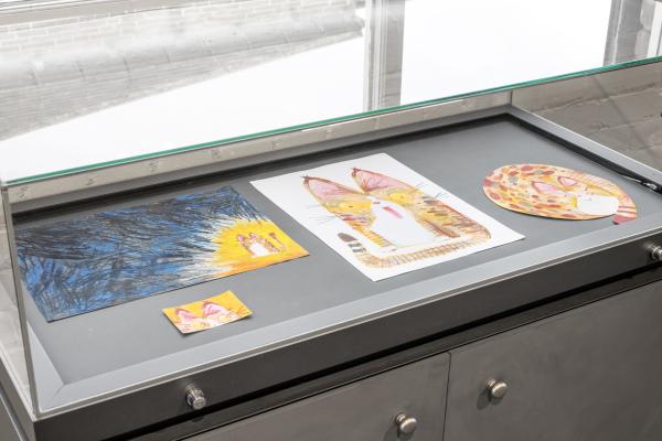 Drawing of Cats in Oil Pastel under glass of vitrine