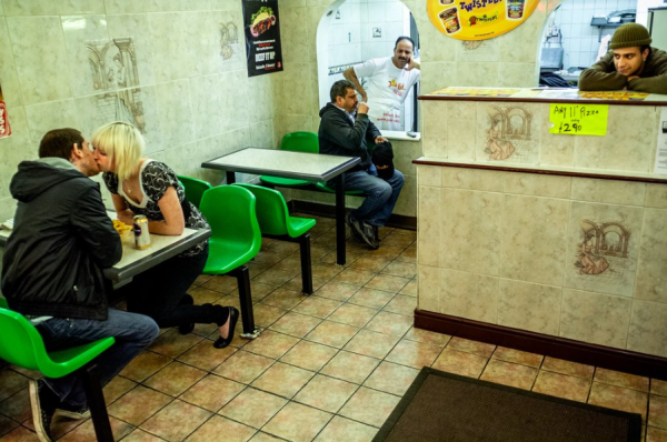 photo of a couple kissing in a takeaway.