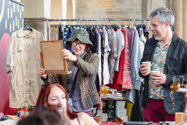 CUSTOMERS ENJOYING LOOKING AT A STALL