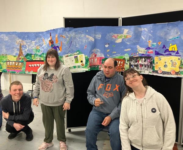 Pyramid's Next Step group stand in front of their artwork