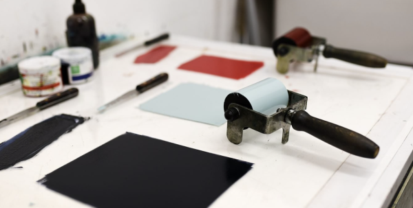 Ink rollers and ink ready to roll out with, in light blue and red.