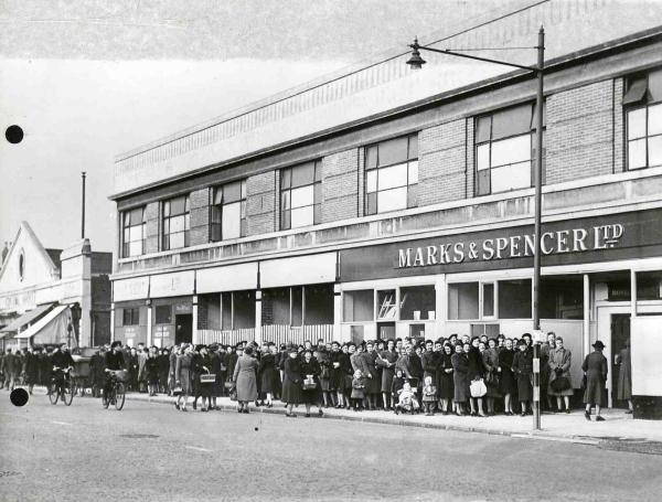 A queue of people outside a temporary M&S store